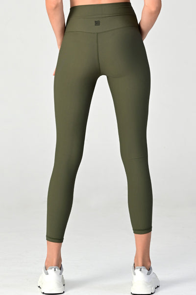 Woman wearing the Melrose army ribbed leggings close up back view.