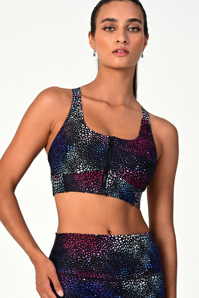Front view of a woman posing wearing the Soho galaxy active bra top.