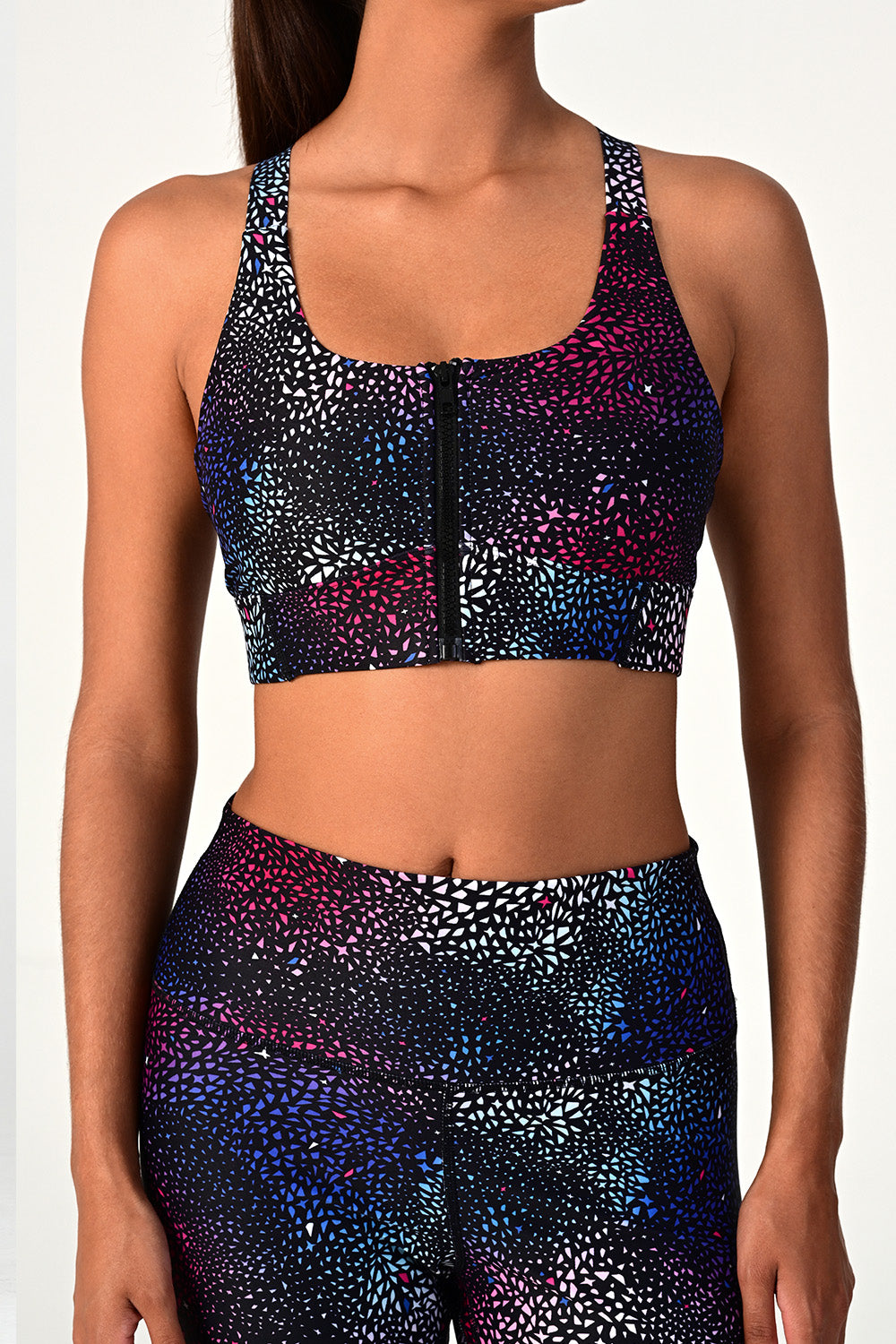 Front view of a woman's body wearing the Soho galaxy active bra top and leggings..