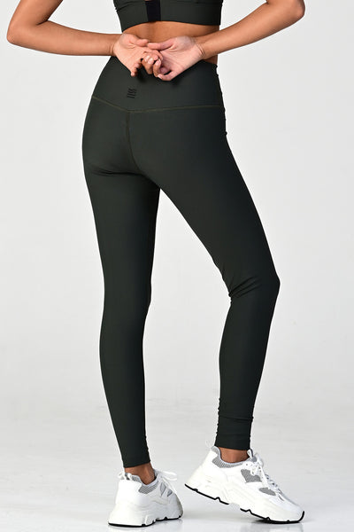 Back view of a woman posing wearing the soho olive active legging
