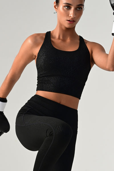 Woman exercising and wearing the Hollywood longline bra top front view.