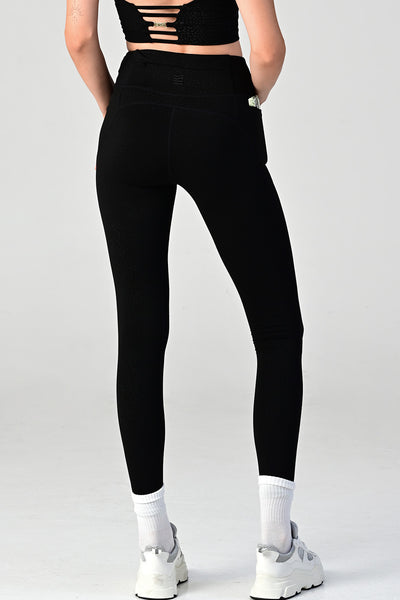 Woman wearing the Hollywood black side pocket legging back view.