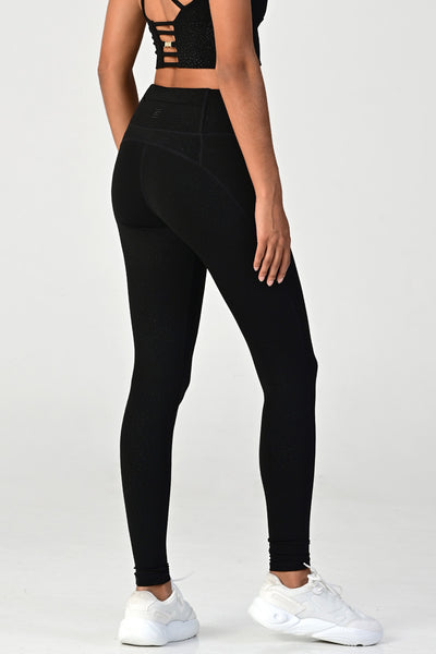Woman wearing the Hollywood black side pocket legging side close up view.
