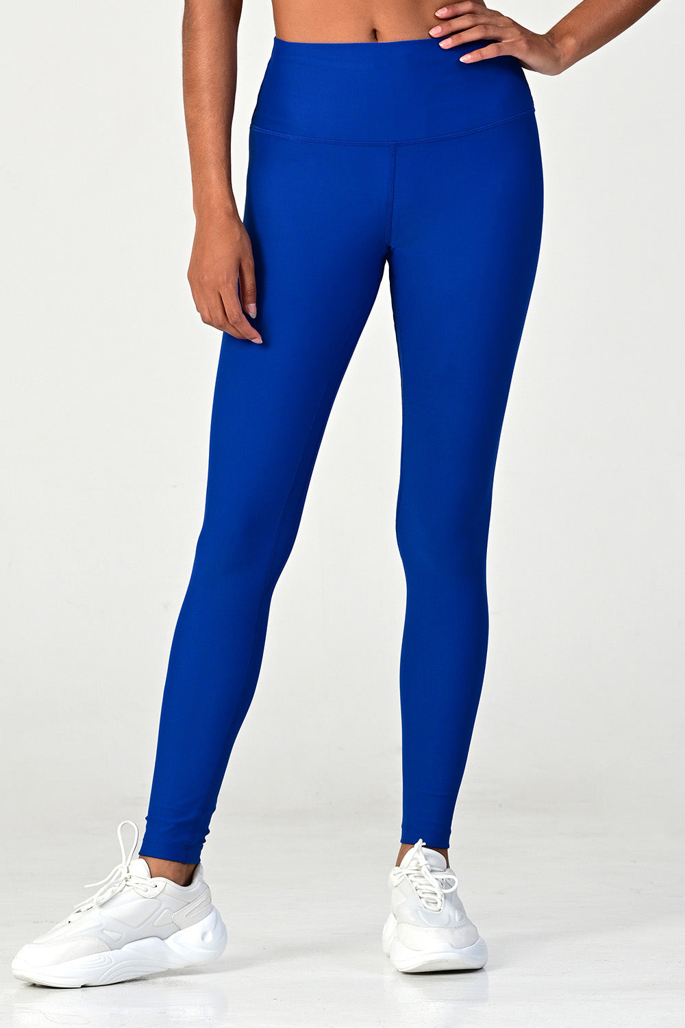 Front view of a woman posing wearing the soho cobalt active legging.