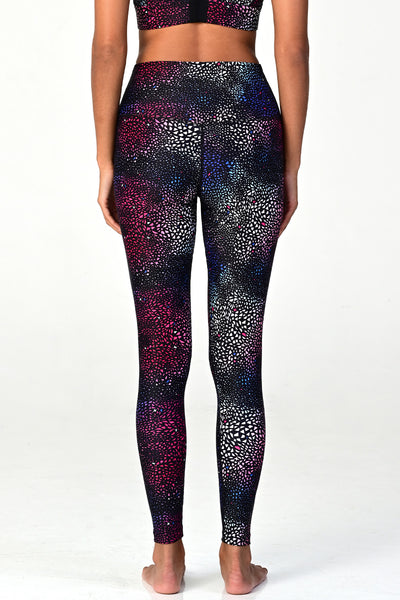 Woman wearing the Soho Galaxy active legging on white background back view. 