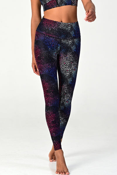 Woman wearing the Soho Galaxy active legging on white background. 