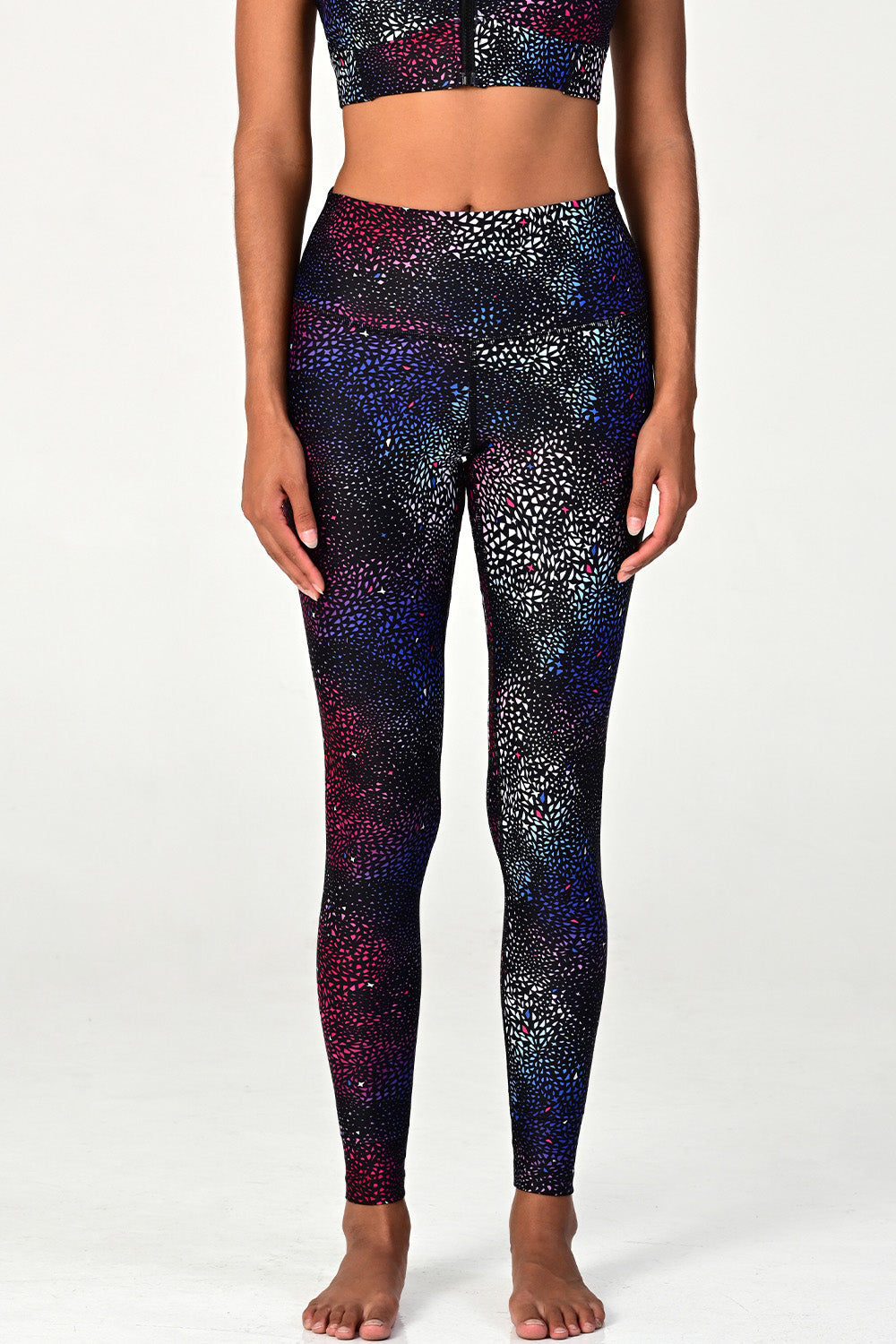 Woman wearing the Soho Galaxy active legging on white background front view. 