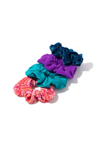 Four Scrunchies in different colors on white background